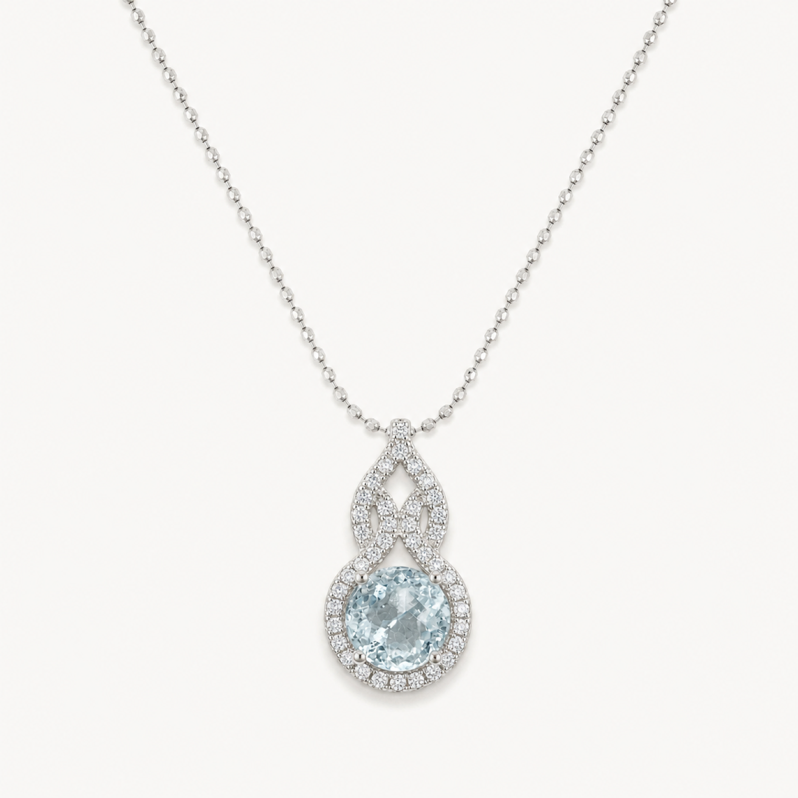 The Serena Natural Aquamarine Cushion Pendant on warm white