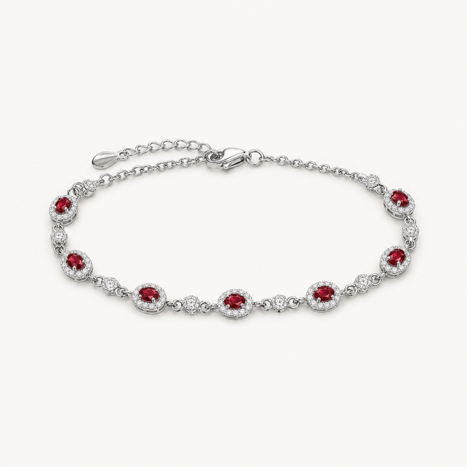 The Amara Ruby Oval Tennis Bracelet on a warm white background