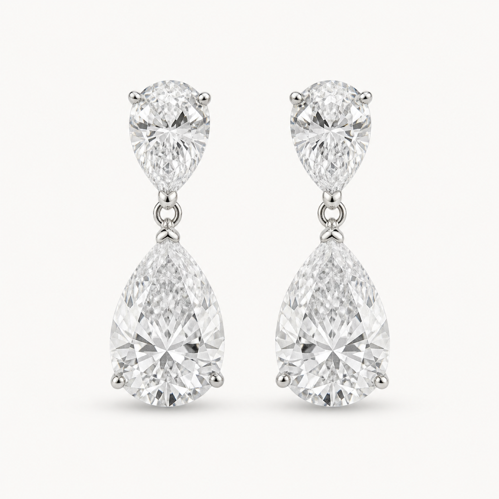 The Aveline Pear-Drop Stud Earrings on a warm white background