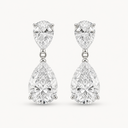 The Aveline Pear-Drop Stud Earrings on a warm white background