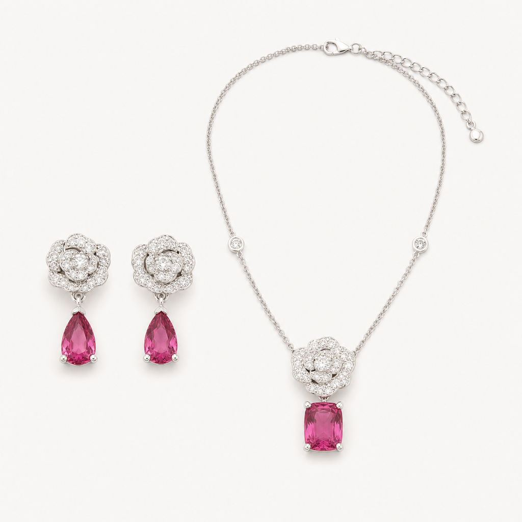 Camellia blush halo necklace and earrings on warm white