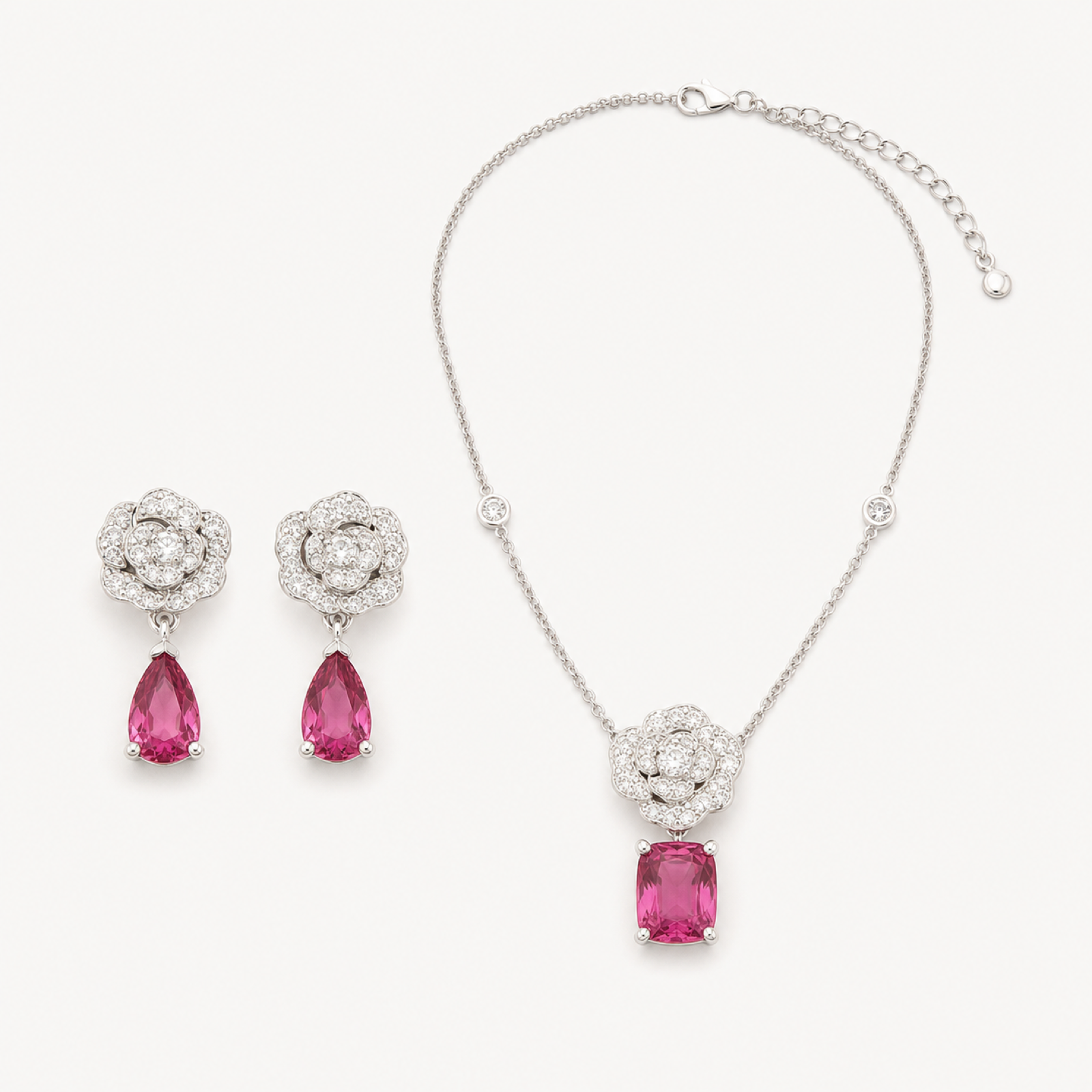 Camellia blush halo necklace and earrings on warm white