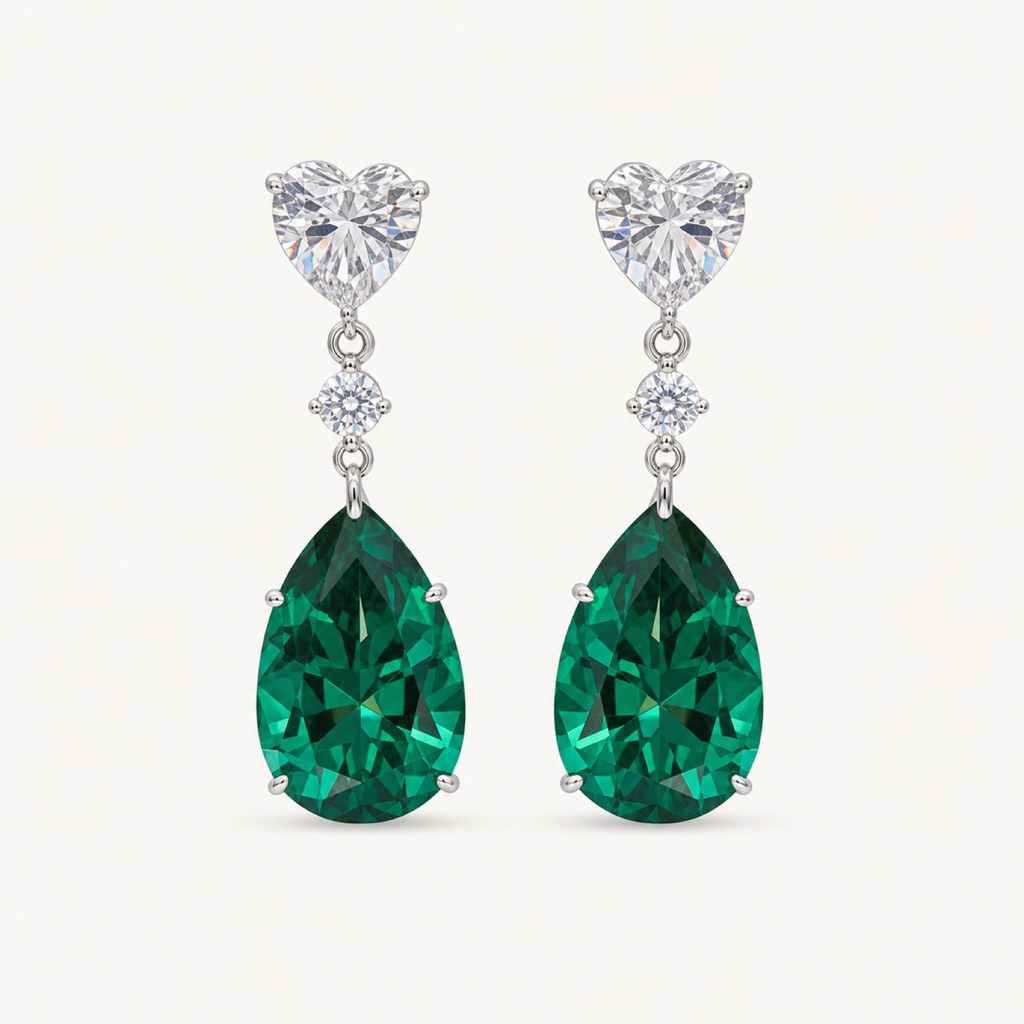 The Celeste Green Pear Drop Earrings on a warm white background