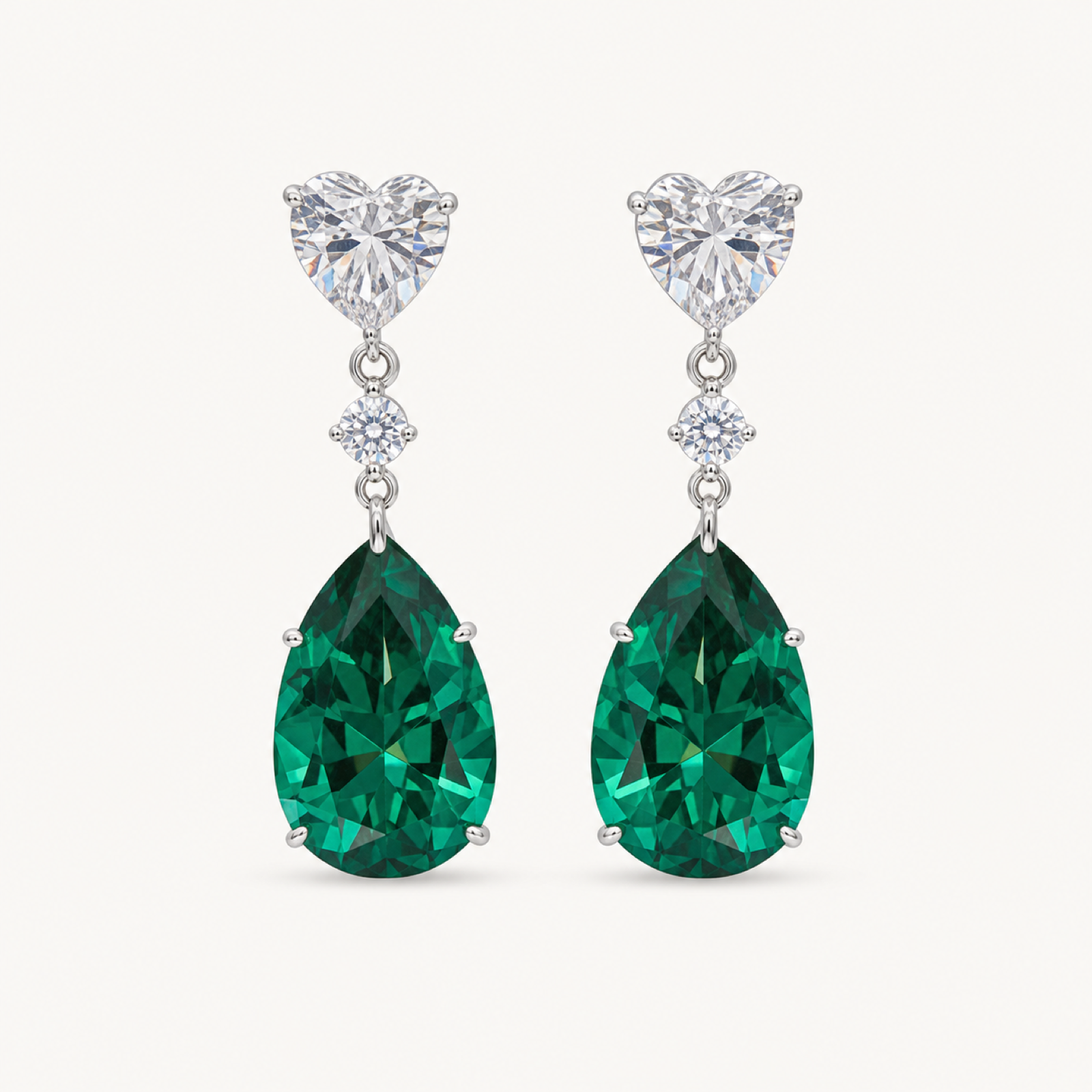 The Celeste Green Pear Drop Earrings on a warm white background