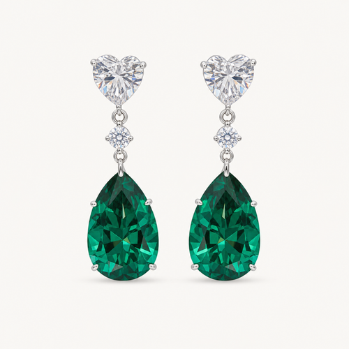 The Celeste Green Pear Drop Earrings on a warm white background