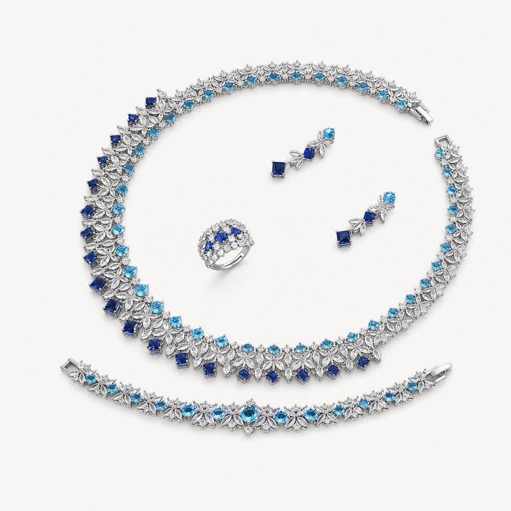 The Celestine Sapphire-Blue Leaf Jewelry Set on a warm white background