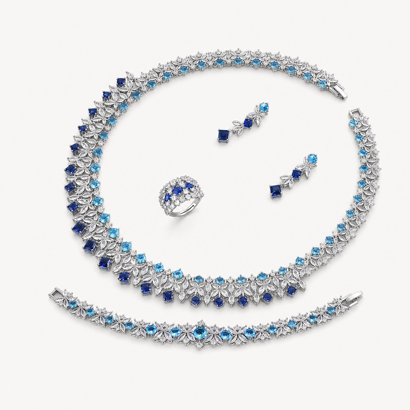 The Celestine Sapphire-Blue Leaf Jewelry Set on a warm white background