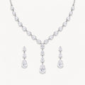The Delphine Pear-Drop Necklace & Earrings Set on a warm white background