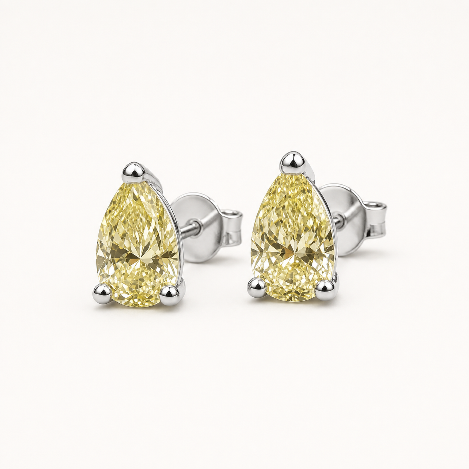 Elodie pear cut earrings on warm white