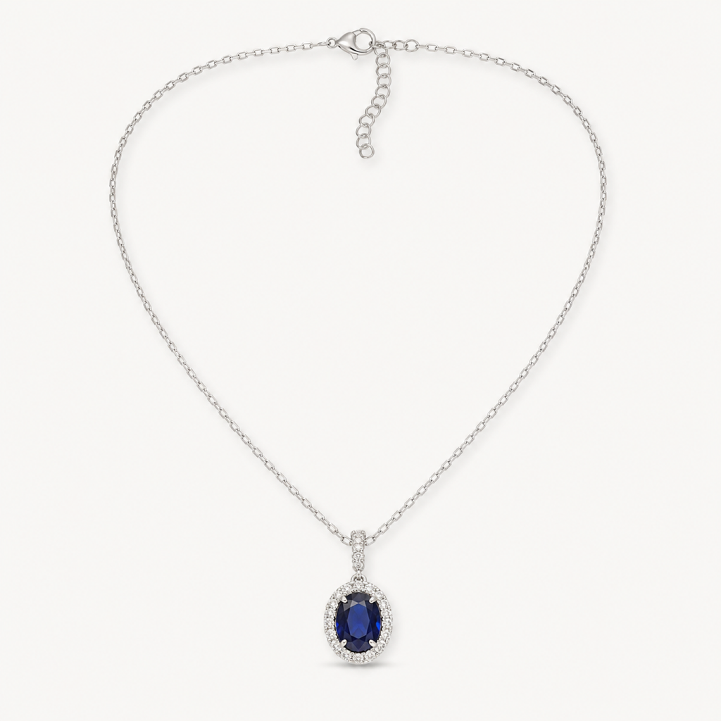 Isolde royal blue oval halo pendant necklace on warm white