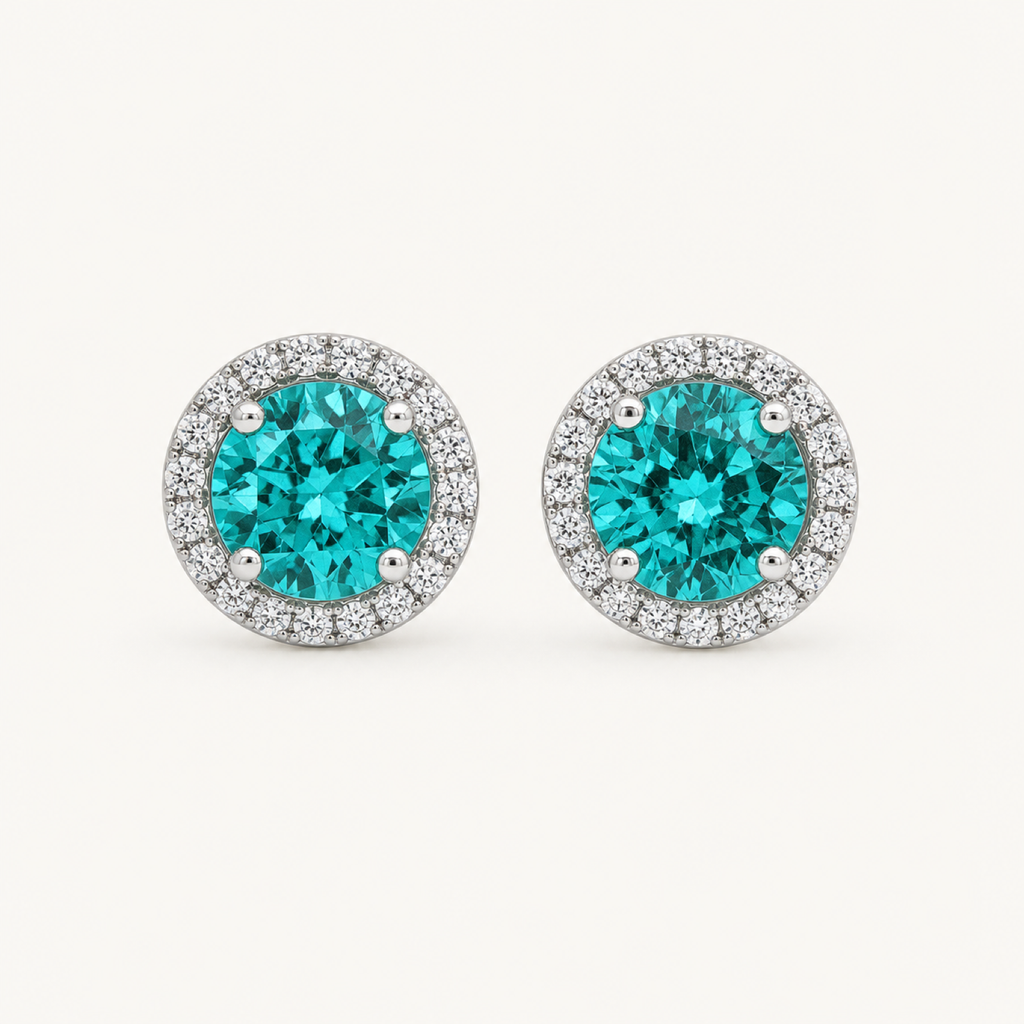 The Noelle Paraiba Blue Round Stud Earrings on warm white