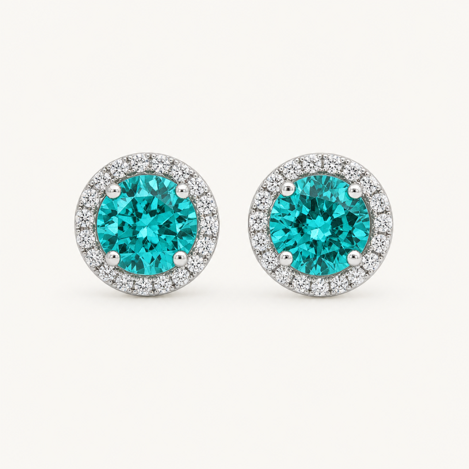 The Noelle Paraiba Blue Round Stud Earrings on warm white