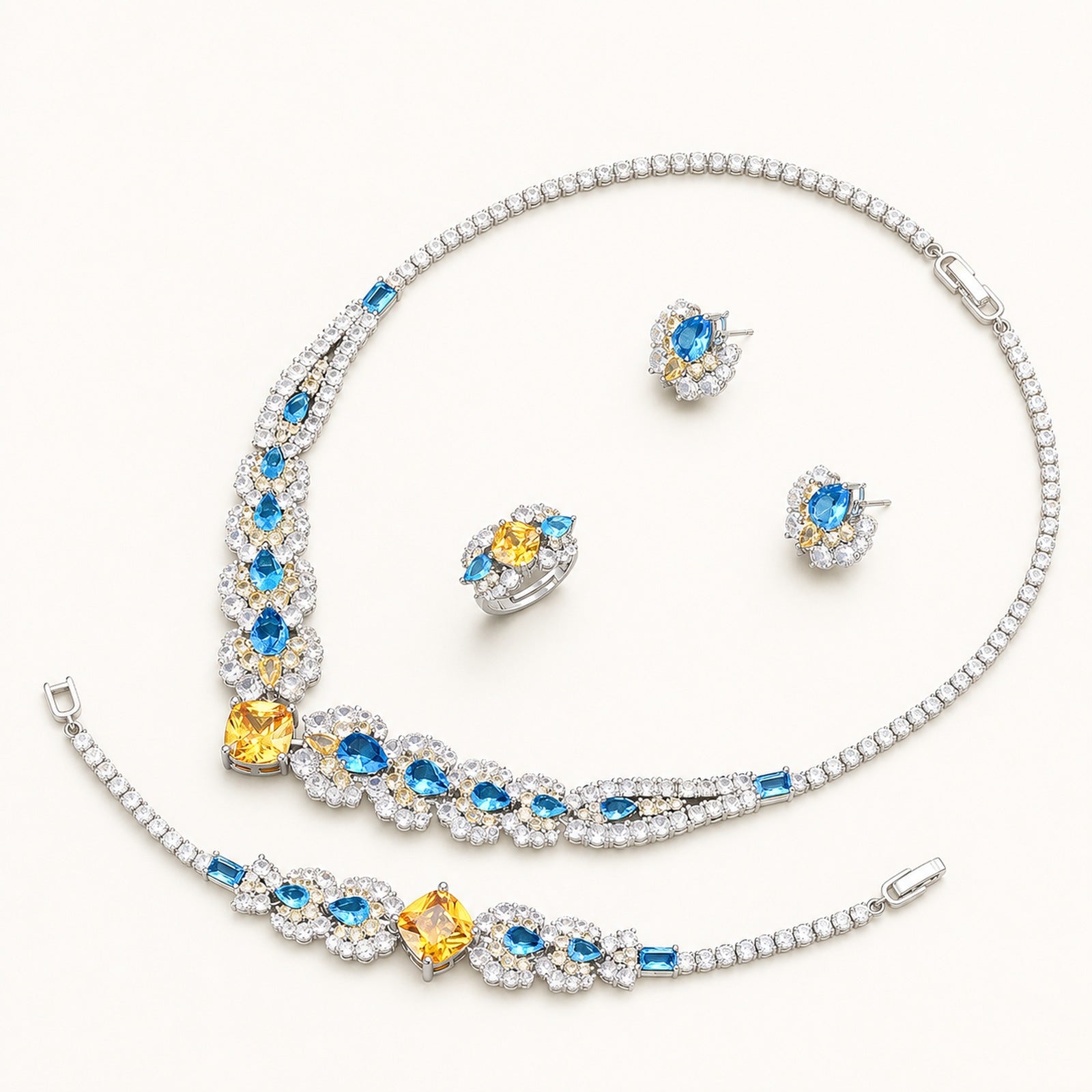 The Soleil Blue & Gold Floral Jewelry Set on a warm white background