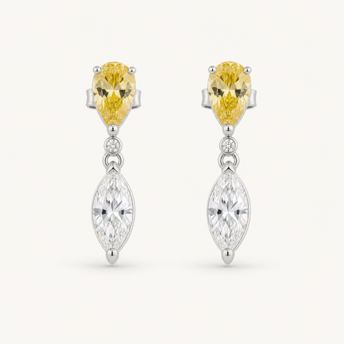The Soleil Two-Tone Marquise Drop Earrings on warm white
