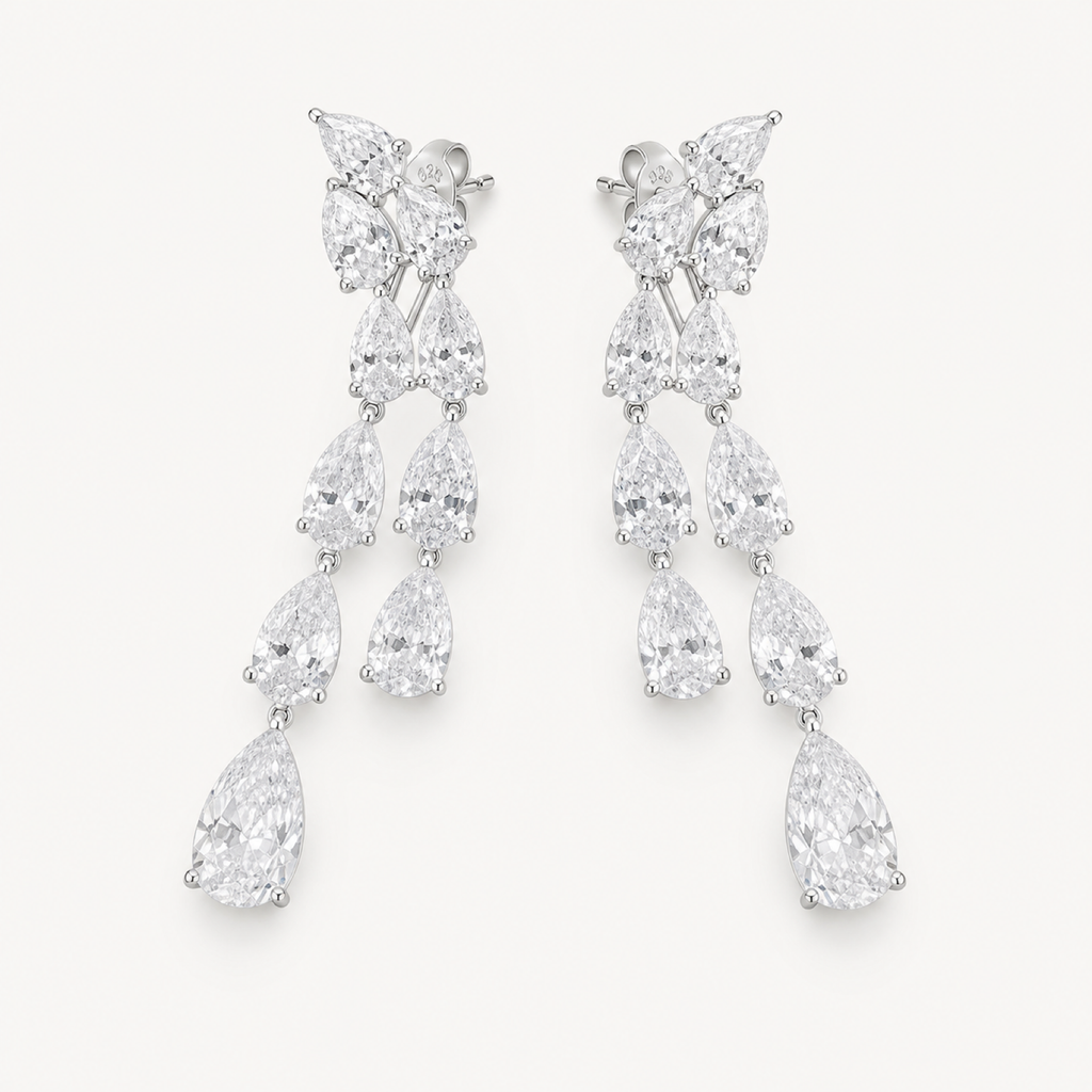The Vivienne Pear-Drop Chandelier Earrings on warm white
