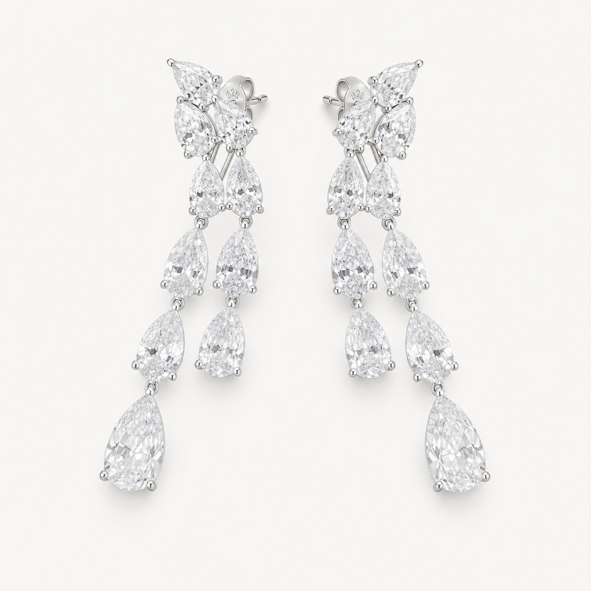 The Vivienne Pear-Drop Chandelier Earrings on warm white